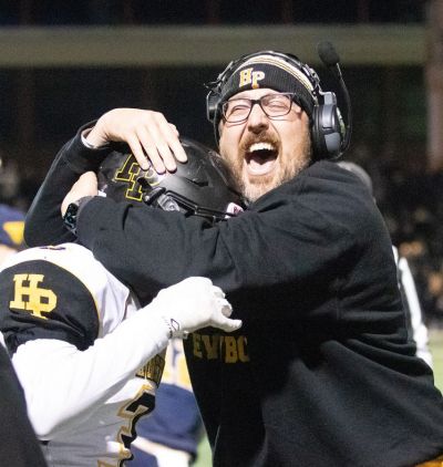 Hanover Park High School head football coach Dan Fulton hugs Dominic Madera after the Hornets upset the top-seeded Ramsey Rams, 33-21, Friday night in the first round of the state football playoffs. (Nov. 11, 2021) [Lisa Mita | Hanover Eagle (Bernardsville, New Jersey)]