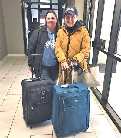 Journal Production Manager Tia LaCombe (left) and Owner/Publisher Cecile Wehrman arrive at their local courthouse with suitcases containing computer equipment to put out the May 4 editions of the Crosby Journal and Tioga Tribune during a five-day power outage, caused by two back-to-back blizzards. The courthouse was the only place they could find with a generator. Wehrman says she s sporting a North Dakota Newspaper Association ball cap because she had not had a chance to shower in three days. “Talk about a bad hair day,” she joked. “But we got our newspapers published.” (provided)