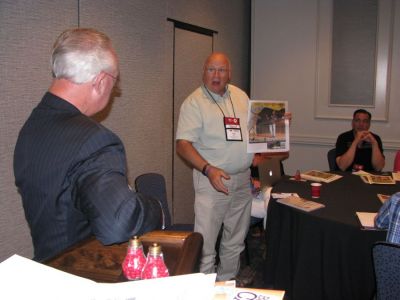 John Galer (right) shares a special section he ran at The Journal-News in Hillsboro, Illinois, at the Great Idea Exchange as part of the 130th Annual Convention & Trade Show in Franklin, Tennessee, moderated by Robert Williams Jr. (left). (Publishers  Auxiliary)