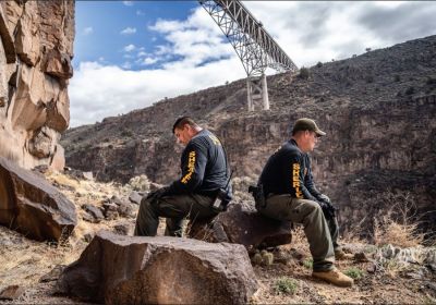 Photo - Best Breaking News Photo
Non-daily Division, circ. 6,000-14,999
FIRST PLACE: The Taos News, Taos, NM, Nathan Burton
Entry: Grim, chaotic, costly

Caption: Taos County Sheriff Steve Miera, left, and deputy Joseph Apodaca take a rest on Wednesday (March 15) during an operation to recover the body of man who jumped to his death from the Rio Grande Gorge Bridge on Tuesday.